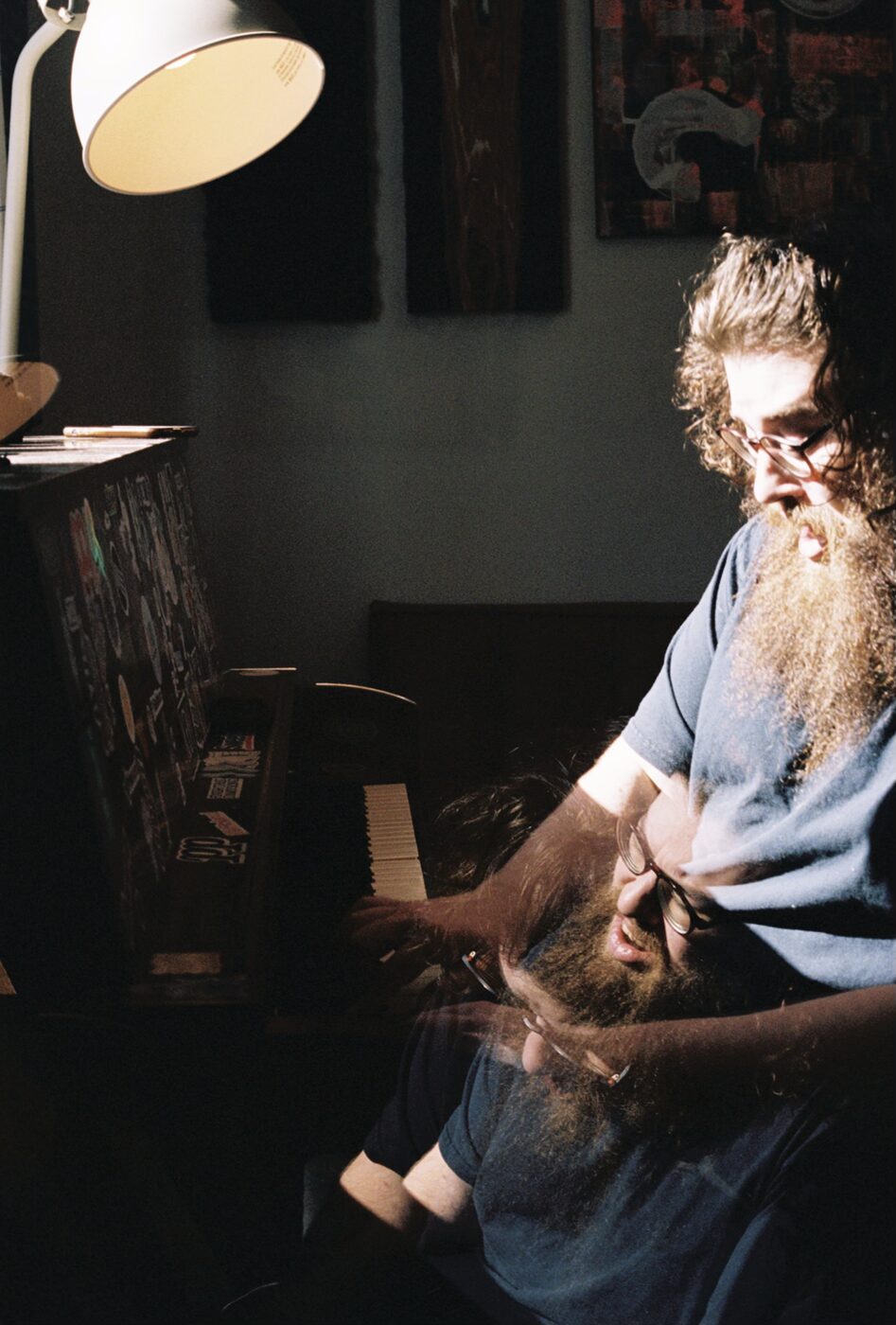 Rob Araujo at the piano, lamp-lit